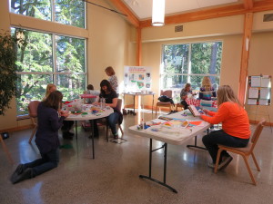 children in the common area partaking in various arts and craft activities