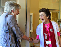 a woman greeter welcoming a woman in the commons