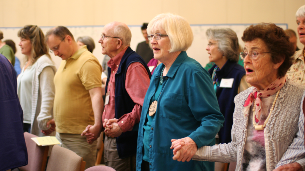 Members holding hands during service