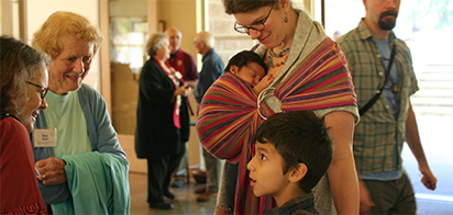 woman with two small children talking to two other women