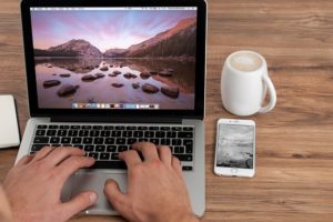 hands typing on a laptop computer
