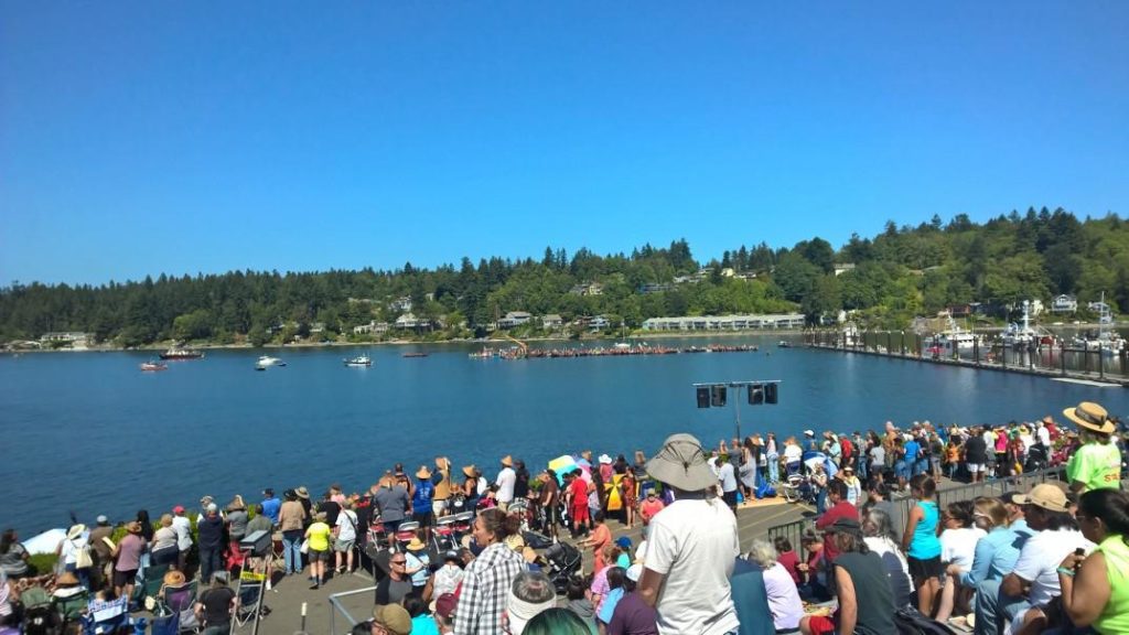 Crowd watching canoes on the Puget Sound