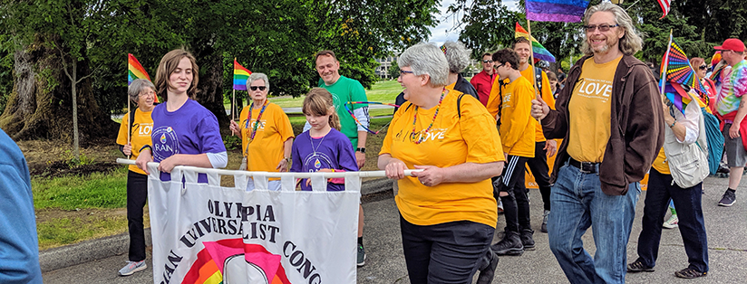 Church members carrying  banner in the Pride parade